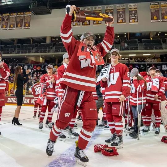 Caroline Harvey lifts the 2023 NCAA National Championship trophy