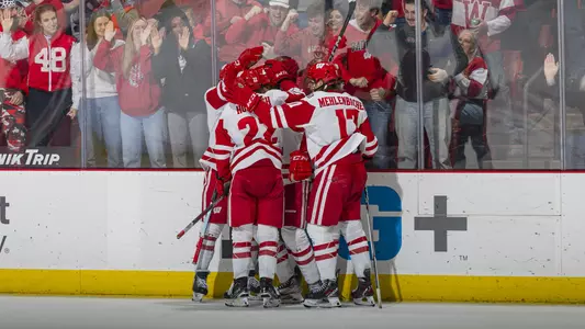 The Wisconsin men's hockey team celebrates scoring a goal against MSU at the Kohl Center.