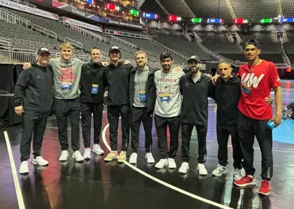 Wisconsin wrestling team at 2024 NCAA Championships at T-Mobile Center in Kansas City, Missouri on March 19, 2024. Pictured left to right: Associate head coach Jon Reader, Shane Liegel, coach Garrett Model, Dean Hamiti, assistant coach Seth Gross, Joseph Zargo, Eric Barnett, head coach Chris Bono and Max Maylor