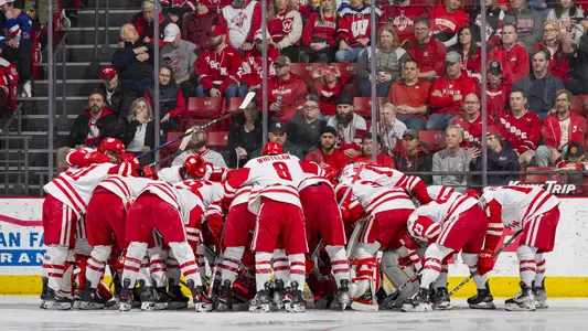 The Wisconsin men's hockey team forms a huddle before a game