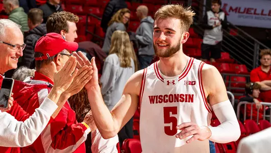 Tyler Wahl high fives a fan after a game