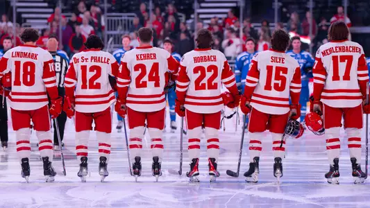 Members of the Badger men's hockey team line up for the national anthem before the 2025 Kwik Trip Holiday Face-Off