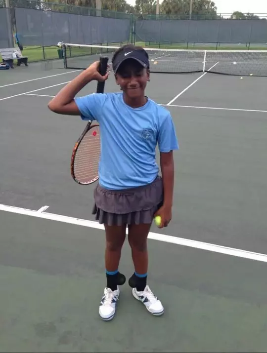 Young Ariel Johnson playing tennis as a child.