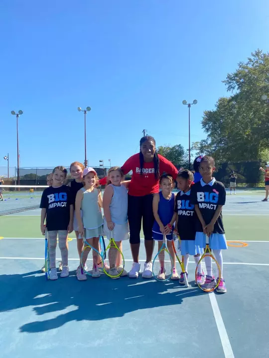 Ariel Johnson stands with kids during Big Ten Impact event in Selma.