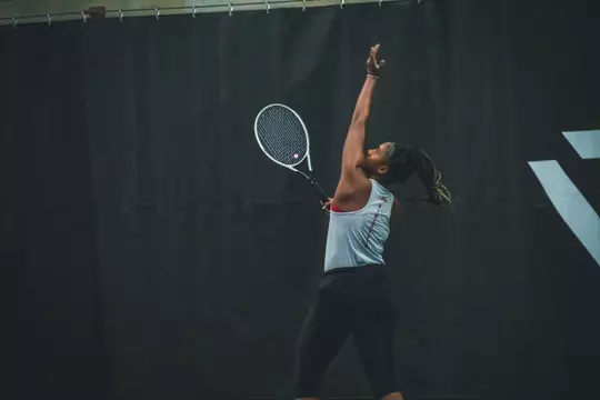 Ariel Johnson throws up the ball to serve