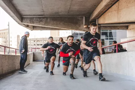 Chez Mellusi and teammates lunge up the ramps of Camp Randall Stadium during Wisconsin football strength and conditioning training session