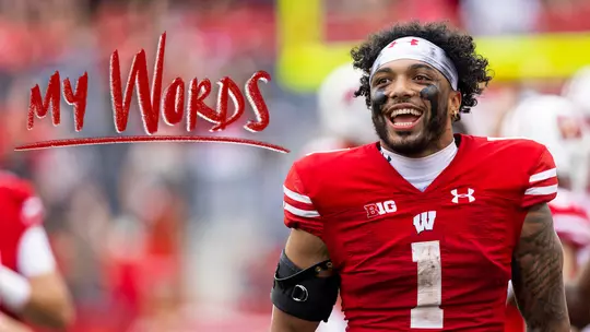 Chez Mellusi, Wisconsin football, smiles in celebration. The "My Words" logo is on the left of the image.