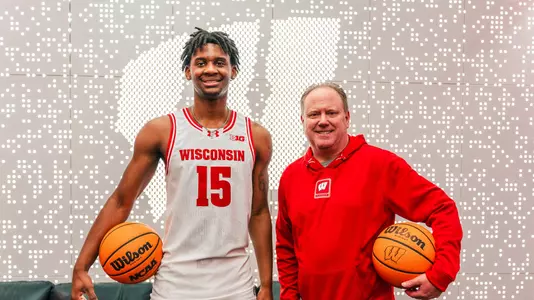 Xavier Amos and head coach Greg Gard pose for a photo