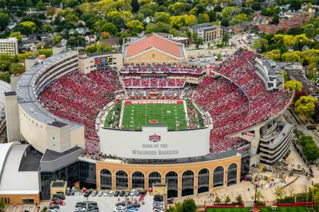 A sea of red- and white-attired fans fill Camp Randall Stadium at the University of Wisconsin–Madison as the Wisconsin Badgers play the Iowa Hawkeyes during a football game on Oct. 14, 2023. The aerial photograph was made from a helicopter looking south during autumn. Wisconsin lost to Iowa, 15-6, before a crowd of 76,205 people. (Photo by Althea Dotzour / UW–Madison)