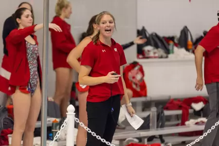 Coach Kristy King cheers on deck during a meet