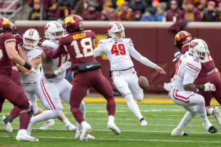 Wisconsin Badgers punter Atticus Bertrams (49) punts the ball during a Big Ten Conference NCAA college football game against the Minnesota Golden Gophers, Saturday, Nov. 25, 2023, in Minneapolis, Min. The Badgers won 28-14. (Photo by David Stluka/Wisconsin Athletic Communications)