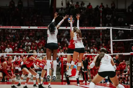 carter Booth and Charlie Fuerbringer block the ball