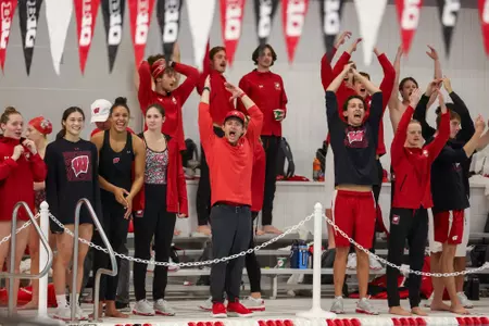 Coach matt cheers on his swimmers
