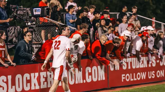 Omar Stefansson walks with fans in the backgroudn