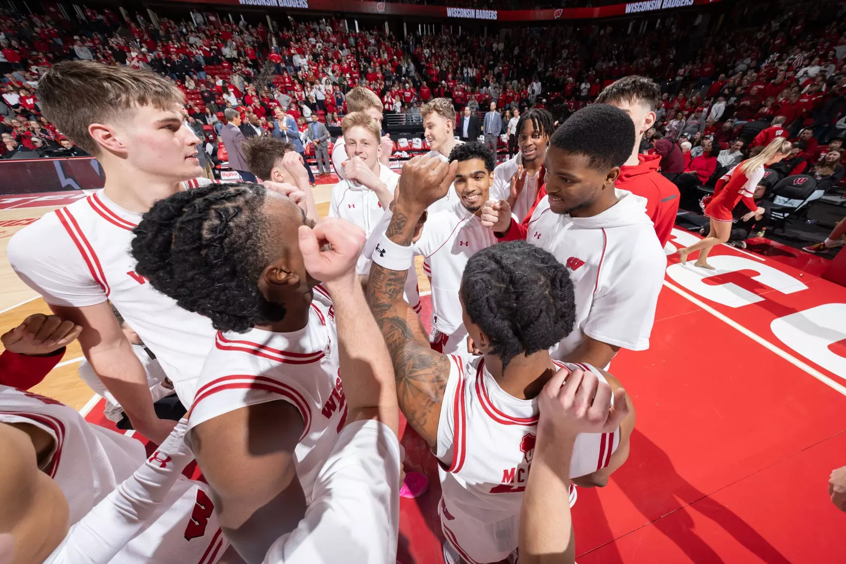 The team warms up for their game against Minnesota