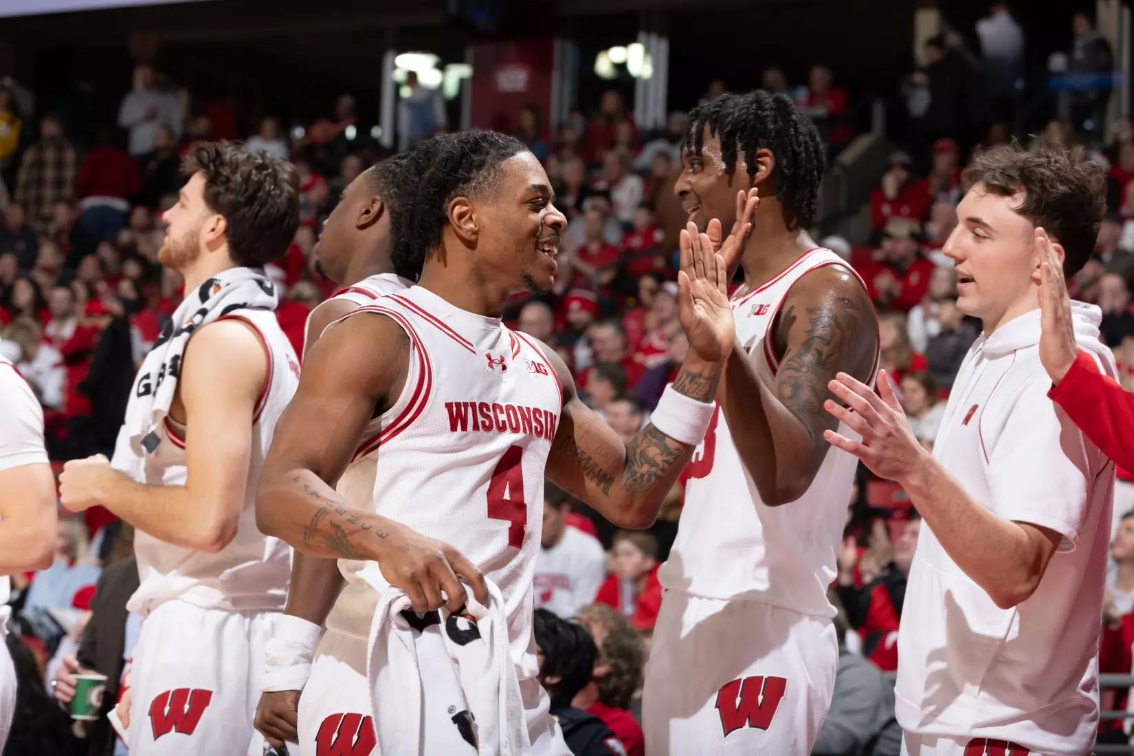 Kamari McGee high fives bench after big win