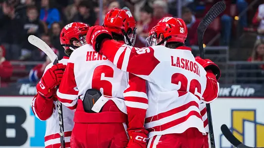 Logan Hensler and the Badger men's hockey team celebrate scoring a goal at the Kohl Center