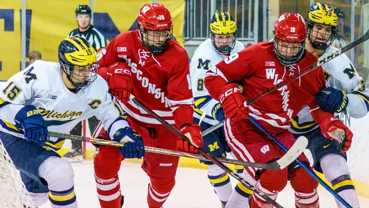 Quinn Finley & Tyson Dyck hustle for the puck at Michigan