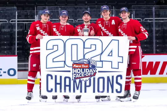 Zach Schulz, Quinn Finley, Dan Laatsch, Joe Palodichuk and Sawyer Scholl with the 2024 Kwik Trip Holiday Face-Off Championship banner