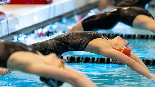 Maggie Wanezek does a backstroke start in meet vs Northwestern