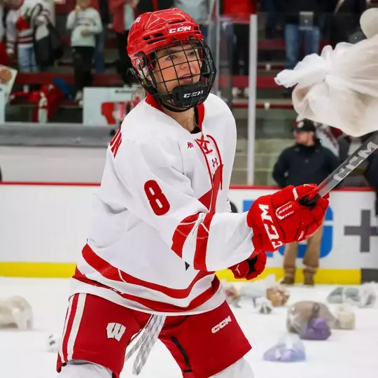 Hannah Halverson plays with a bear from the Teddy Bear Toss after the game vs St. Cloud State
