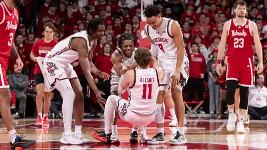 Max Klesmit is helped up the floor in a game against Nebraska