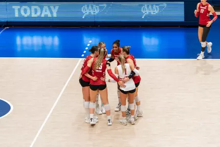 The Badgers huddle before a rally against Penn State.