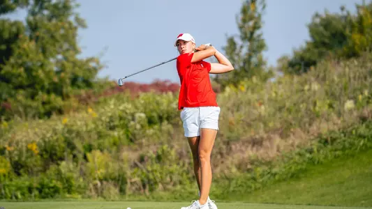 Sophomore Izzi Stricker fires approach at Badger Invitational