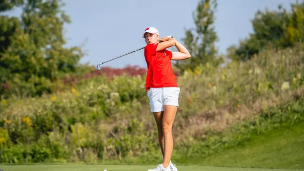 Sophomore Izzi Stricker fires approach at Badger Invitational
