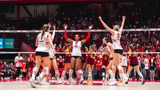 Carter Booth celebrates with teammates after winning a point against Minnesota.