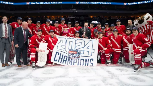 Wisconsin men's hockey poses with the 2024 Kwik Trip Holiday Face-Off trophy