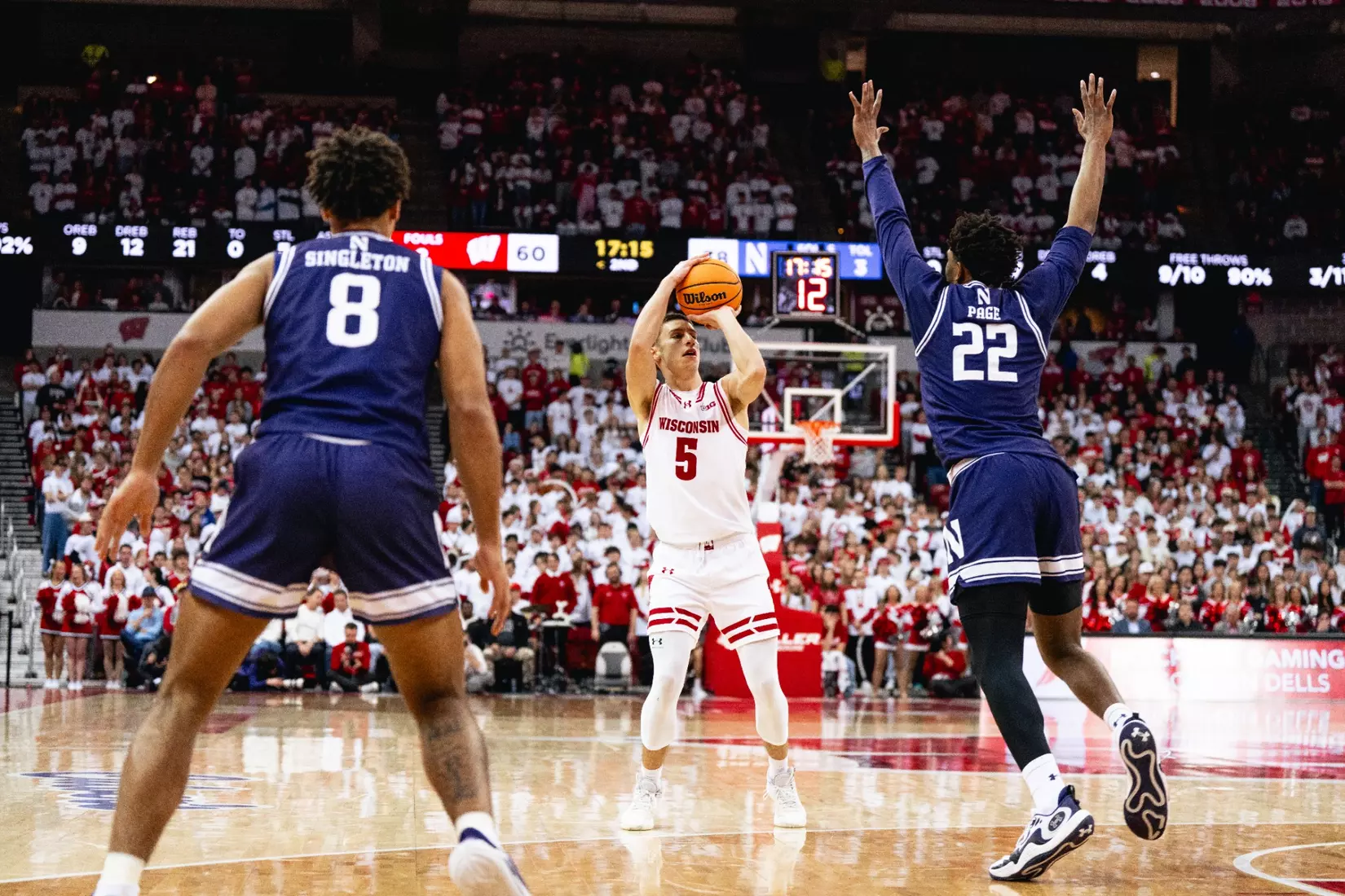 Jack Janicki fires three-pointer over Northwestern defenders.