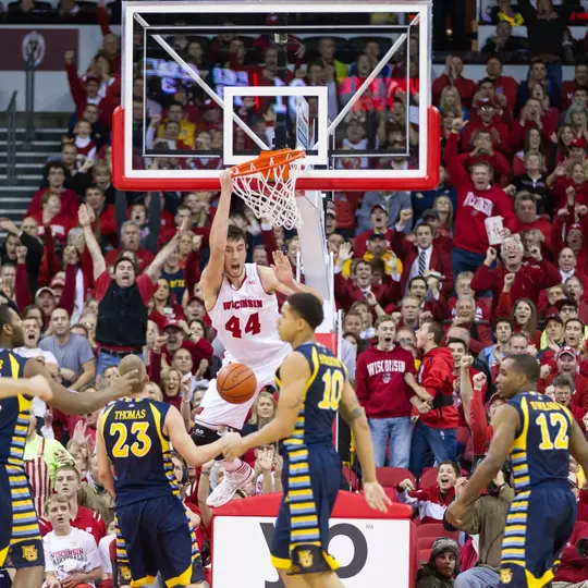 Frank Kaminsky nearly pulls the rim off with a monsterous dunk during a Non-Conference NCAA college basketball game featuring The Wisconsin Badgers Vs. The Marquette Golden Eagles on Saturday, December 7, 2013 in Madison, Wisconsin. The Badgers won 70-64. Photo: Steve Gotter