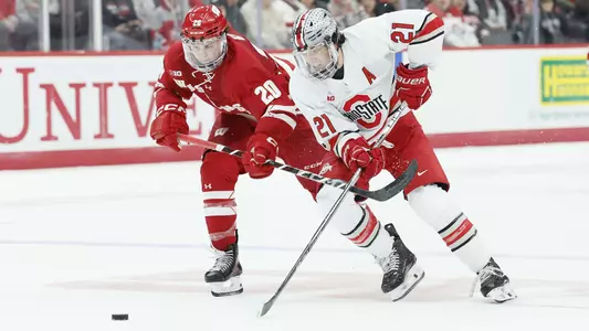 Weston Knox rushes for the puck at Ohio State