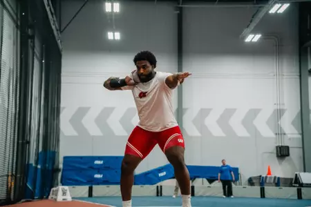 Joseph White sets to throw in the shot put at the DePaul Invite