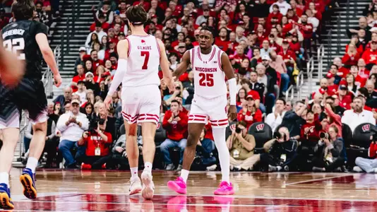 John Blackwell and Carter Gilmore high five in a game against Washington