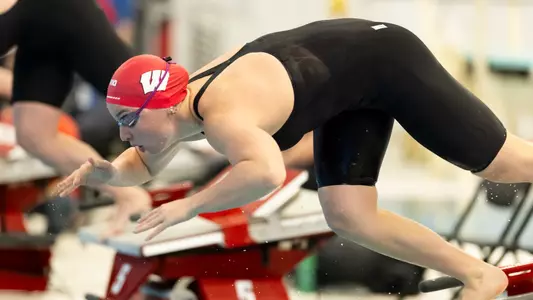 Badger dives off the block in meet vs Northwestern