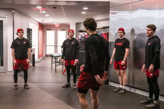 Gavin Morrissey plays sewer ball before a game with his teammates