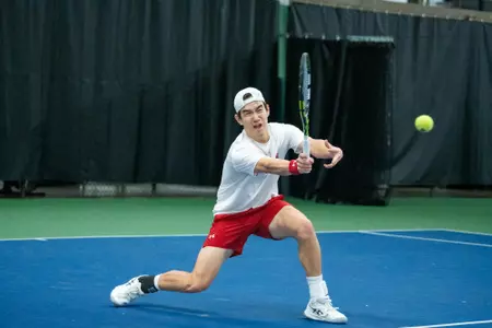 Matthew Fullerton returns a shot