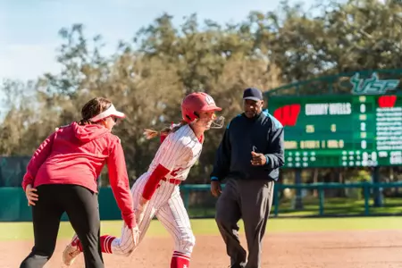 Dani Lucey rounds third base after homering against Louisville