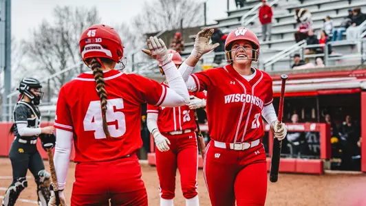 Ellie Hubbard high fives Alivia Bark in a series sweep over Iowa
