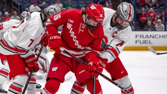Tyson Dyck battles for the puck against an OSU skater