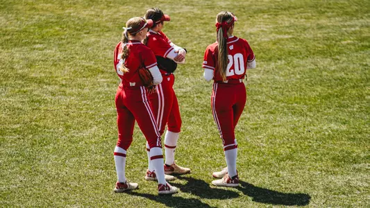 The Badger outfielders meet up in a game against Indiana