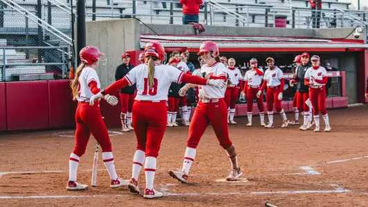 Ellie Hubbard greets her teammates at the plate against NDSU