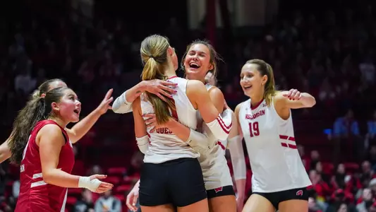 Charlie Fuerbringer hugs Madison Quest in spring match vs Marquette