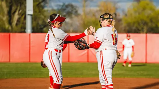 Gabi Salo and Hilary Blomberg meet at the mound