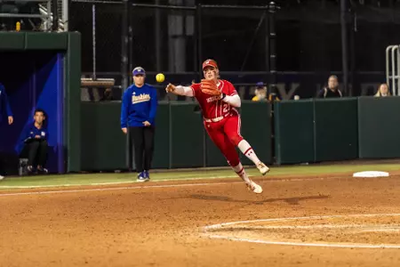 Hilary Blomberg throws on the run to get the runner out at first vs Washington April 4, 2025