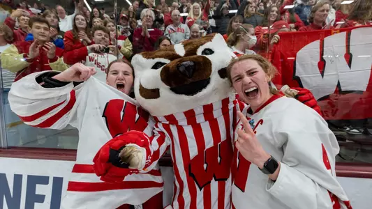Wisconsin Badgers goalie Ava McNaughton (30), Bucky Badger and Caroline Harvey (4) celebrate after the NCAA college Women’s Frozen Four Final hockey game against the Ohio State Buckeyes, Sun., Mar. 23, 2025, in Minneapolis, Min. The Badgers won 4-3 in overtime. (Photo by David Stluka/Wisconsin Athletic Communications)