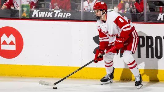 Logan Hensler possess the puck