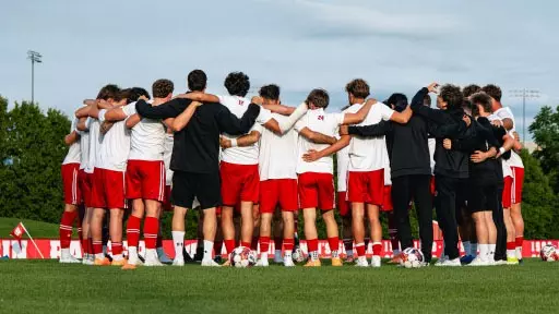 Men's soccer huddles before exhibition match vs. Drake